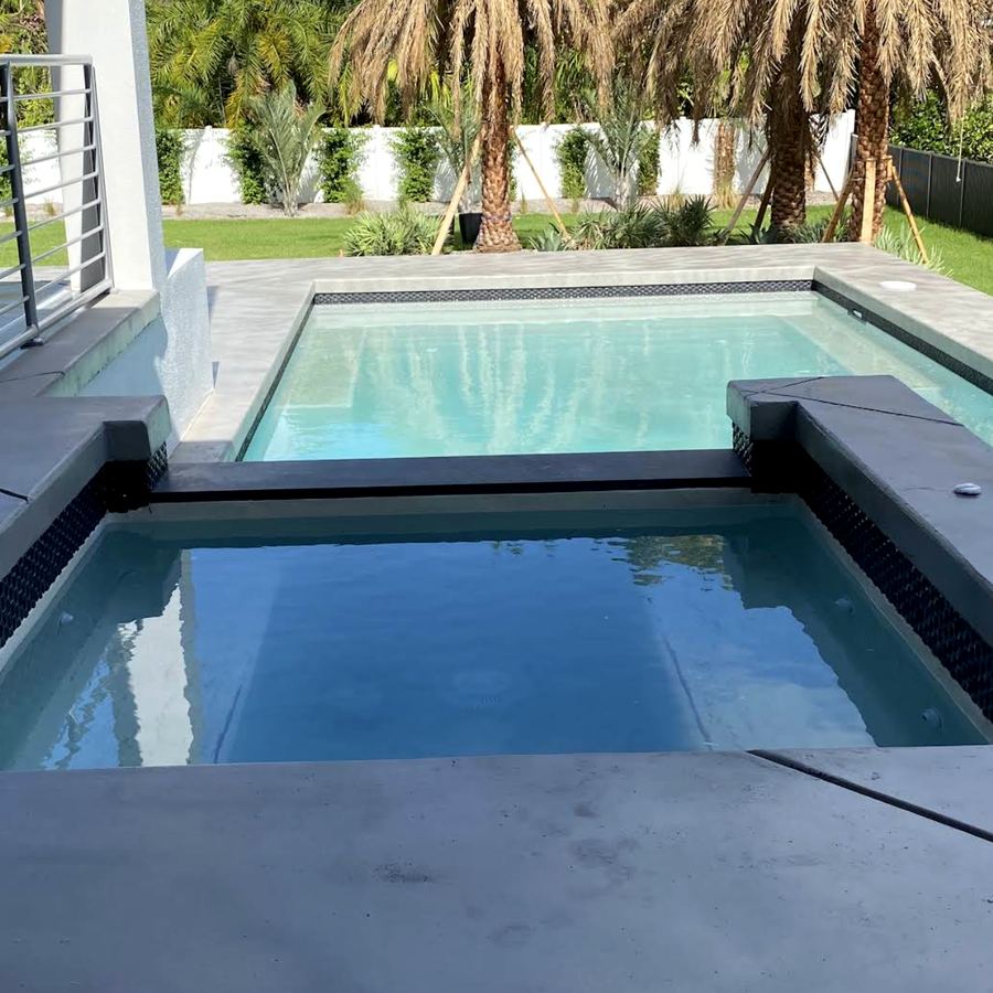 Modern pool and spa concrete deck